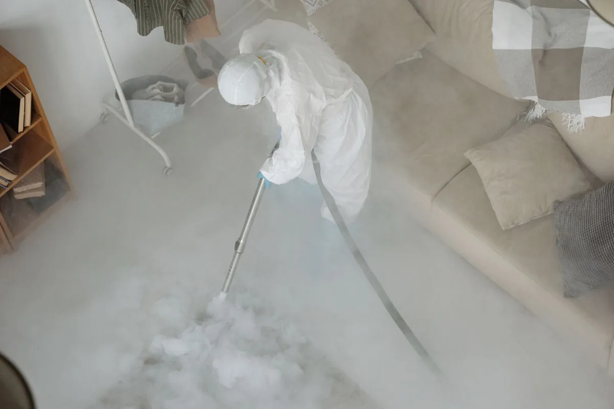 Biohazard cleanup technician in protective equipment, Mather, CA